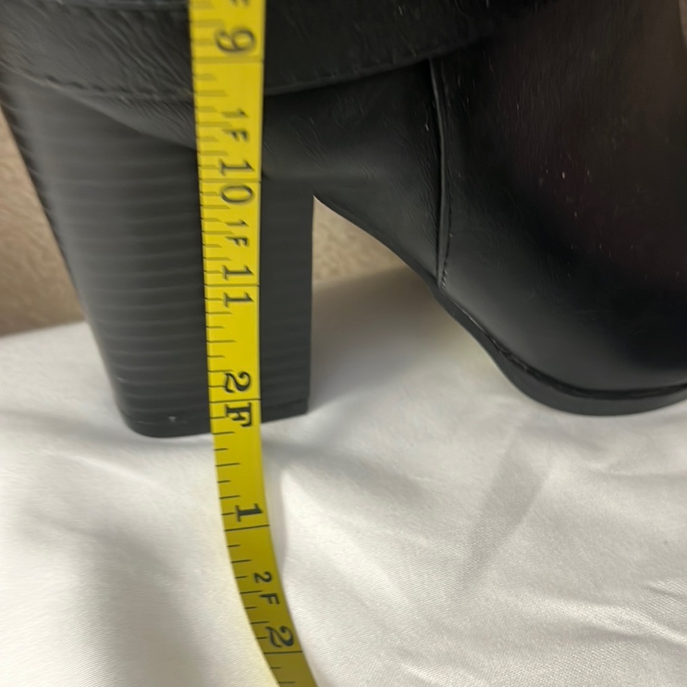 An above knee black 3 inch stacked heeled boot.